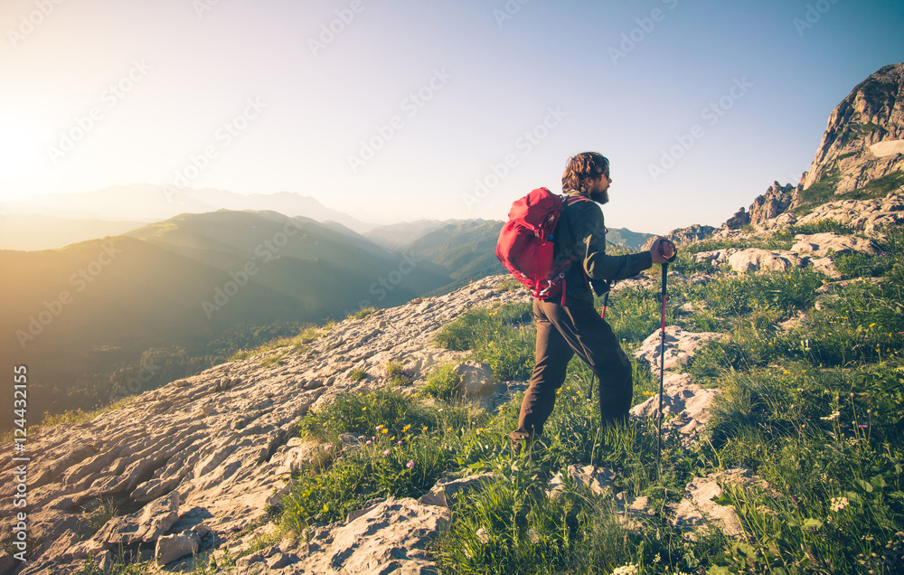 Man Traveler with backpack hiking outdoor Travel Lifestyle concept mountains on background Summer vacations