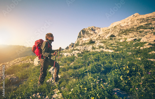 Young Man with backpack mountaineering outdoor Travel Lifestyle concept mountains on background Summer vacations © EVERST
