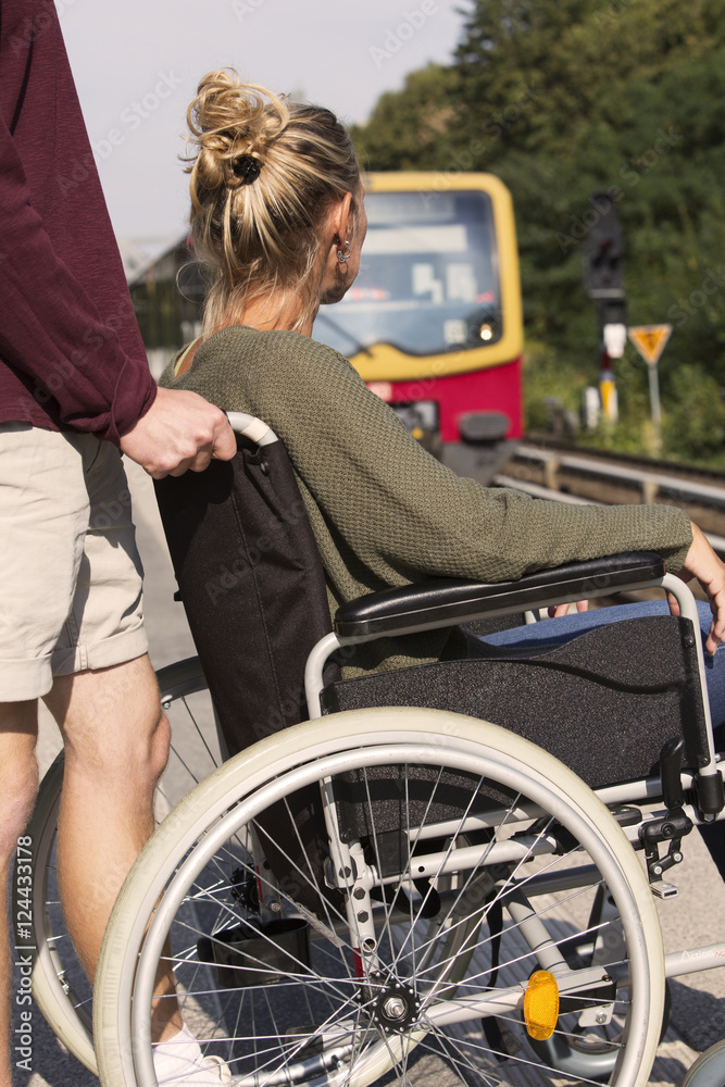 woman in wheelchair at a train station woman in wheelchair at a train station