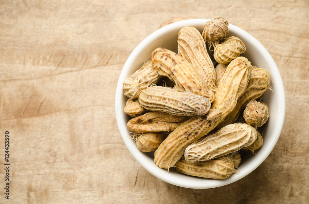 Boiled peanuts or groundnuts in a bowl on wooden background Boiled peanuts or groundnuts in a bowl on wooden background