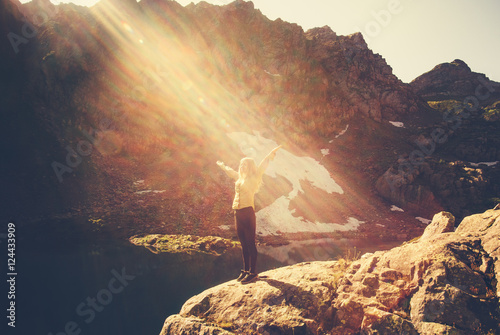 Woman Traveler meditating yoga relaxing alone standing on cliff sun light Travel healthy Lifestyle concept lake and rocky mountains landscape on background outdoor