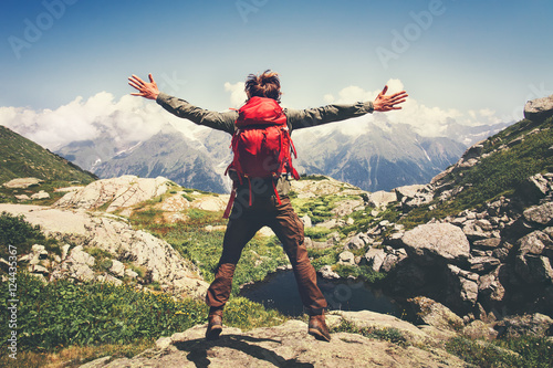 Traveler Man with backpack jumping hands raised mountains landscape on background Lifestyle Travel happy emotions success concept summer vacations outdoor. © EVERST
