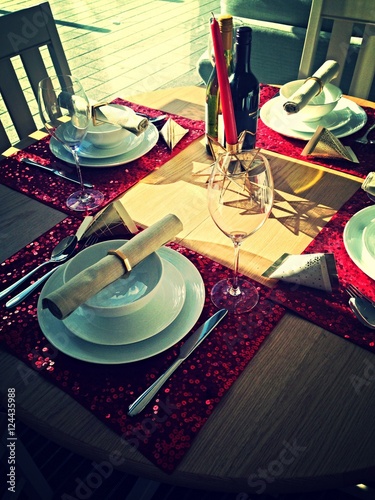 Red sparkling  fine dinning table setting for four  photo