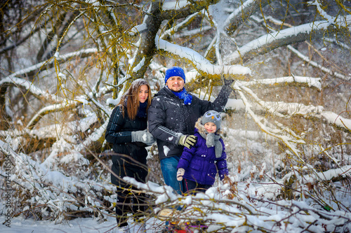 close-knit, cheerful family in the winter wood