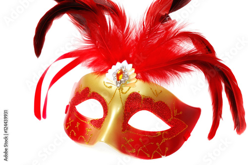 Red Venetian Carnival mask with feathers on the white