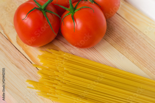 Ingredients for tasty pasta: spaghetti with tomatoes.