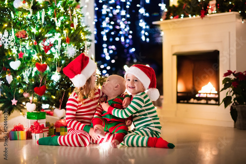 Kids in pajamas under Christmas tree © famveldman