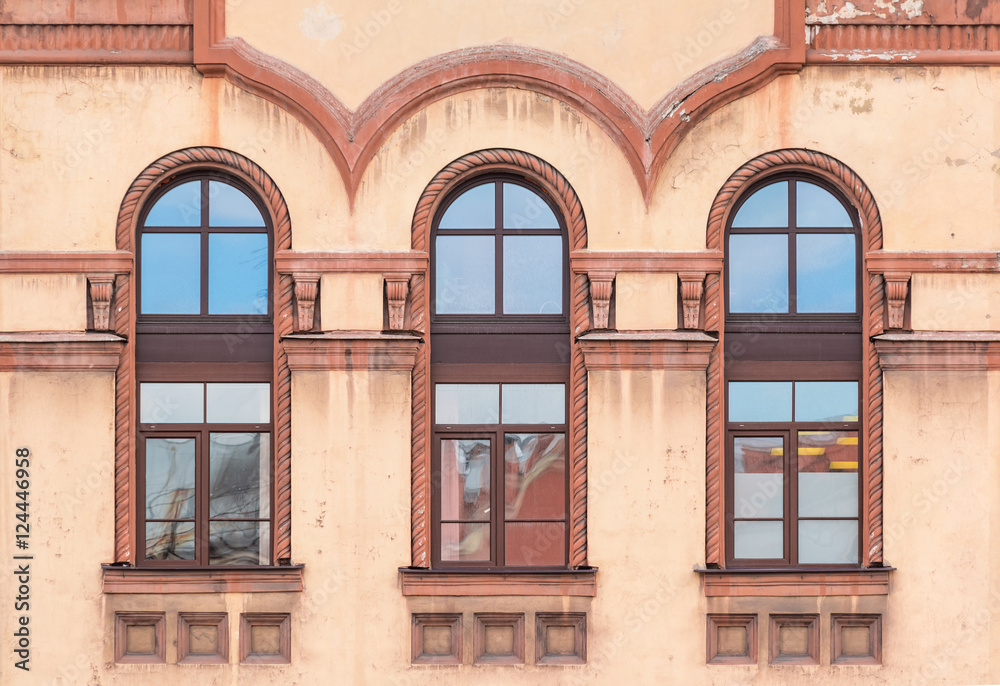 Three windows in a row on facade of St. Petersburg Medical Center front view, Russia.