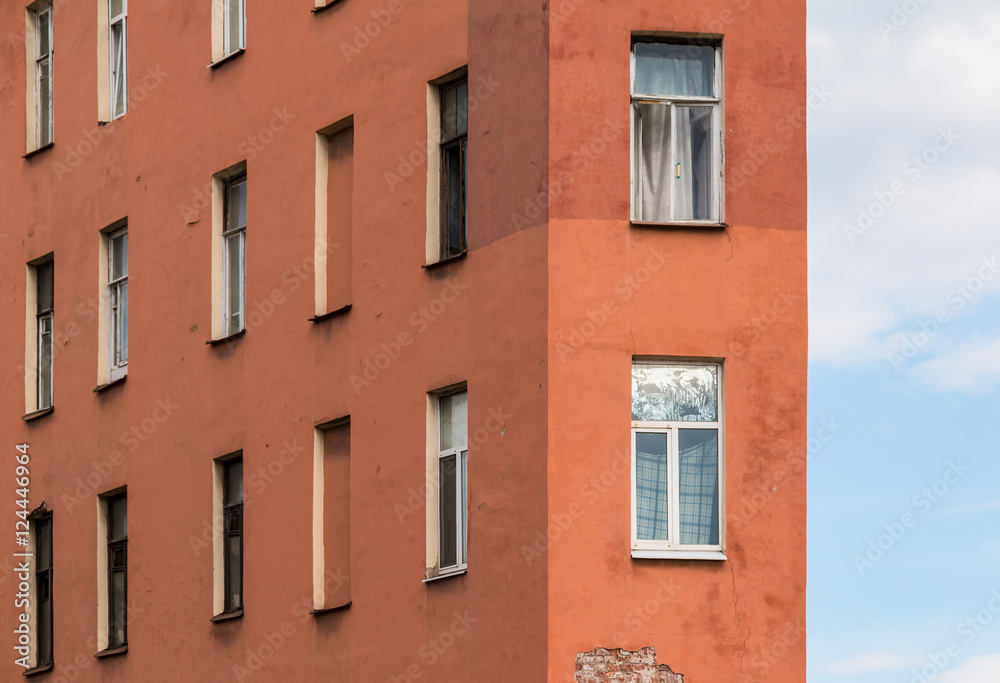 Several windows in a row and corner of facade of urban apartment building front view, St. Petersburg, Russia.