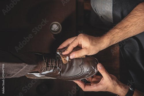 male hands cleansing the shoe