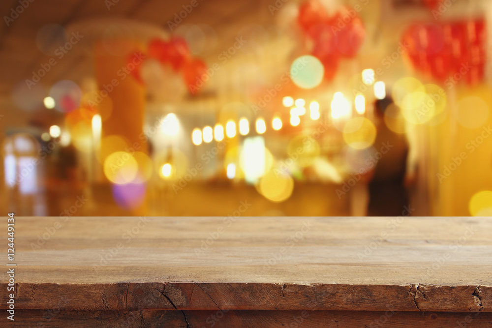 wooden table in front of blurred restaurant lights - obrazy, fototapety, plakaty 
