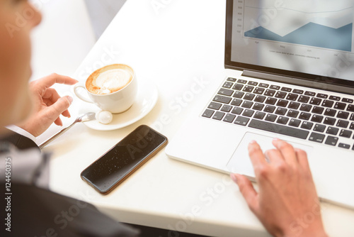 Busy businesswoman using computer in cafe