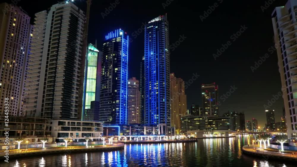 Dubai Marina night time lapse, United Arab Emirates. Dubai Marina - the largest man-made marina in the world. Dubai Marina is a canal city, carved along a 3 km stretch of Persian Gulf shoreline, UAE Dubai Marina night time lapse, United Arab Emirates. Dubai Marina - the largest man-made marina in the world. Dubai Marina is a canal city, carved along a 3 km stretch of Persian Gulf shoreline, UAE