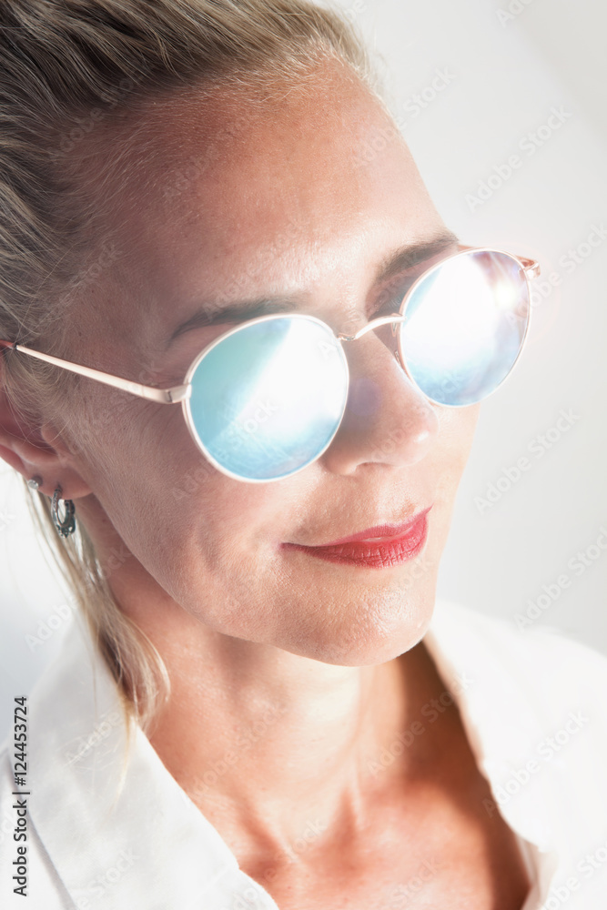 portrait of blond woman with shiny sunglasses portrait of blond woman with shiny sunglasses