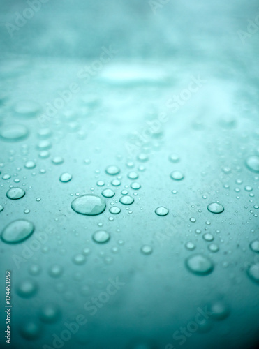 Drops of water on a dusty green color background. Shallow depth of field. Selective focus. Toned.