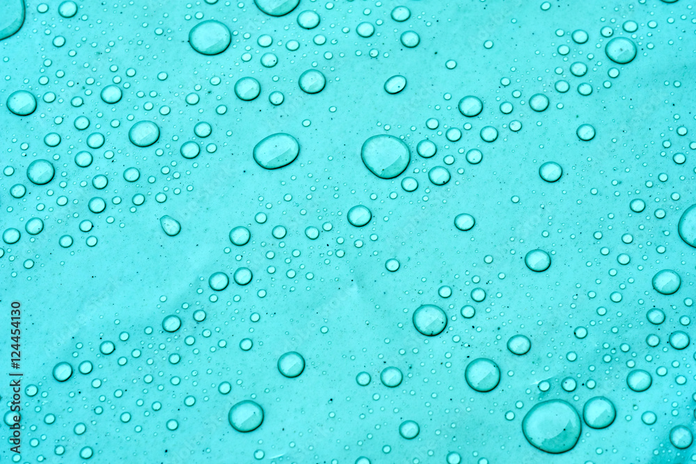 Drops of water on a dusty green color background. Shallow depth of field. Selective focus. Toned.