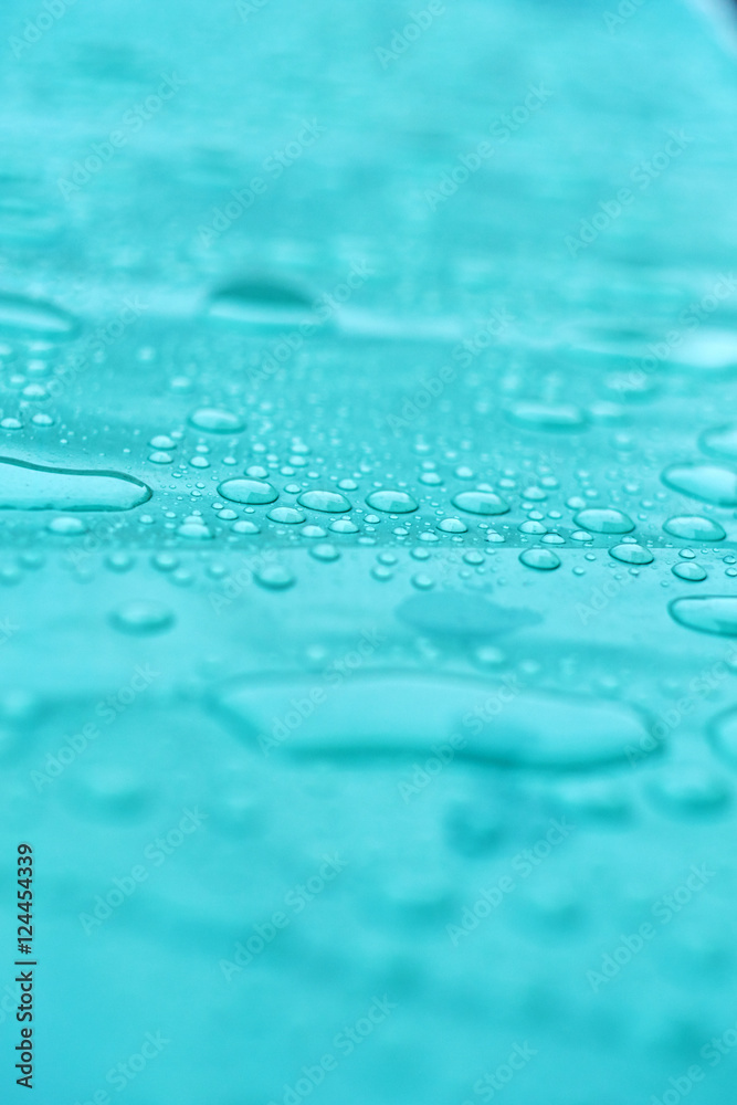 Drops of water on a dusty green color background. Shallow depth of field. Selective focus. Toned.