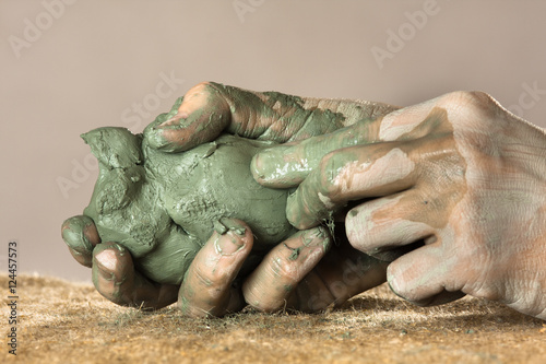 hands moulding from blue clay