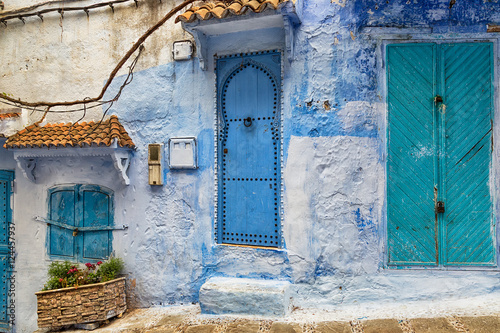 Typical street with ancient stone buildings in Chefchaouen medina in Morocco.
