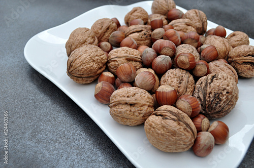 walnuts and hazelnuts on white tray