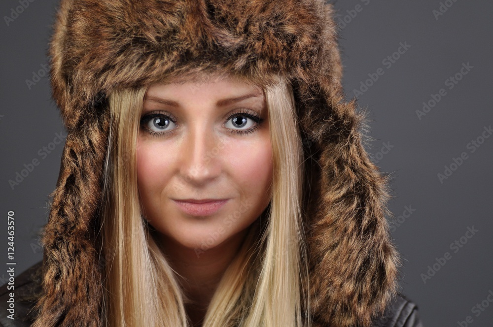 Young, attractive woman in a fur cap. Clothing for the winter. Young, attractive woman in a fur cap. Clothing for the winter.