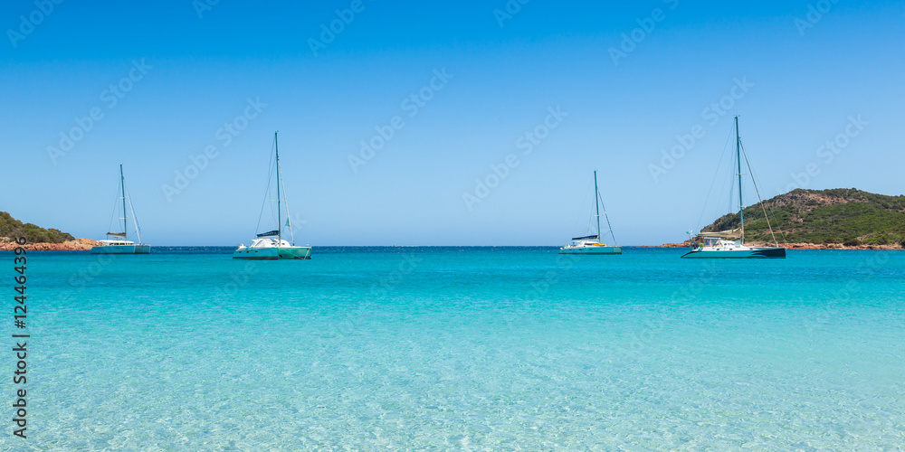 Boats mooring in the turquoise water of Rondinara beach in Cors Boats mooring in the turquoise water of Rondinara beach in Cors
