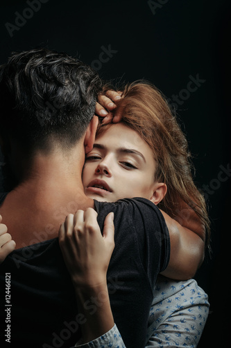 Pretty girl embraces man