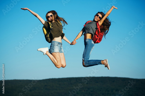 pretty girls jumping on sky