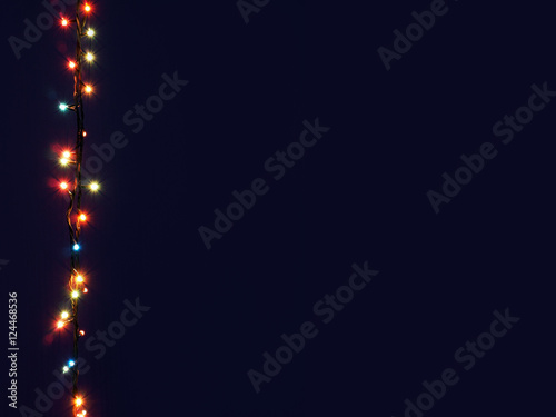 Christmas lights frame on dark background, decorative garland in night space