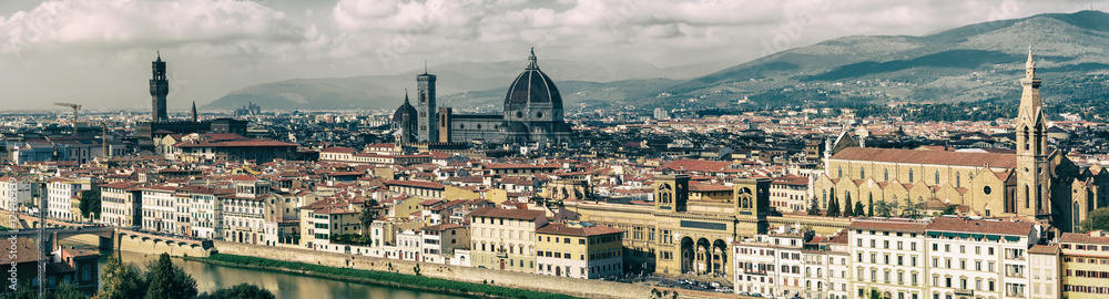 Panoramic view of the beautiful medieval italian city and culture capital - Florence with cathedrals and bridges over river and cloudy sky. Travel outdoor sightseeing historical background.