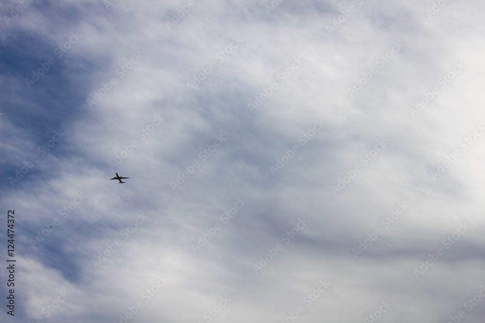 Airplane in the cloudy sky