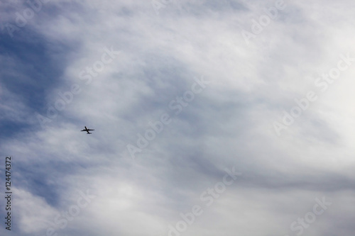 Airplane in the cloudy sky