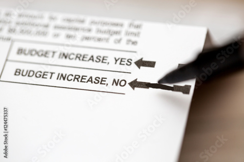 PHOENIX, AZ - OCTOBER 21, 2016: Close up of a pen about to mark the 2016 USA general election early voting ballot form with a vote for Hillary Clinton as president. photo