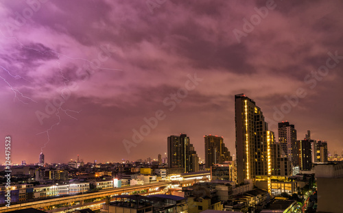 abstract scene of lighting flash in night sky with cityscape