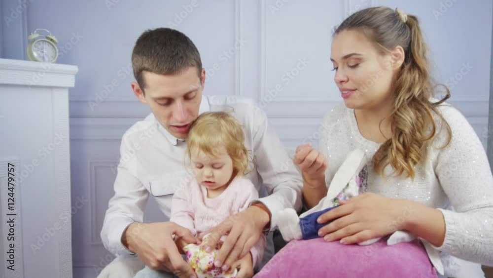 Mother and father playing with their babygirl Mother and father playing with their babygirl
