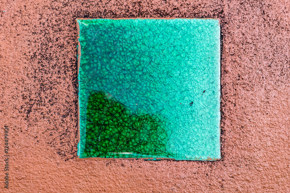 Fototapeta premium Green ceramic tile on concrete