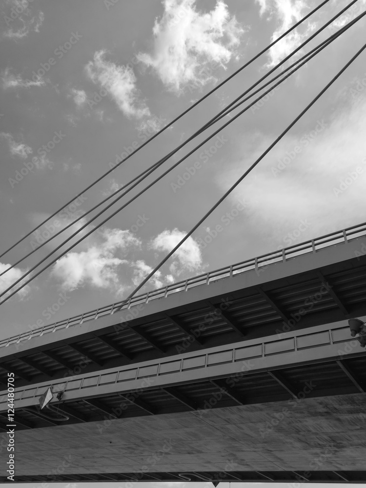 Low angle monochrome view of Danube Bridge against sky and clouds in Bratislava
