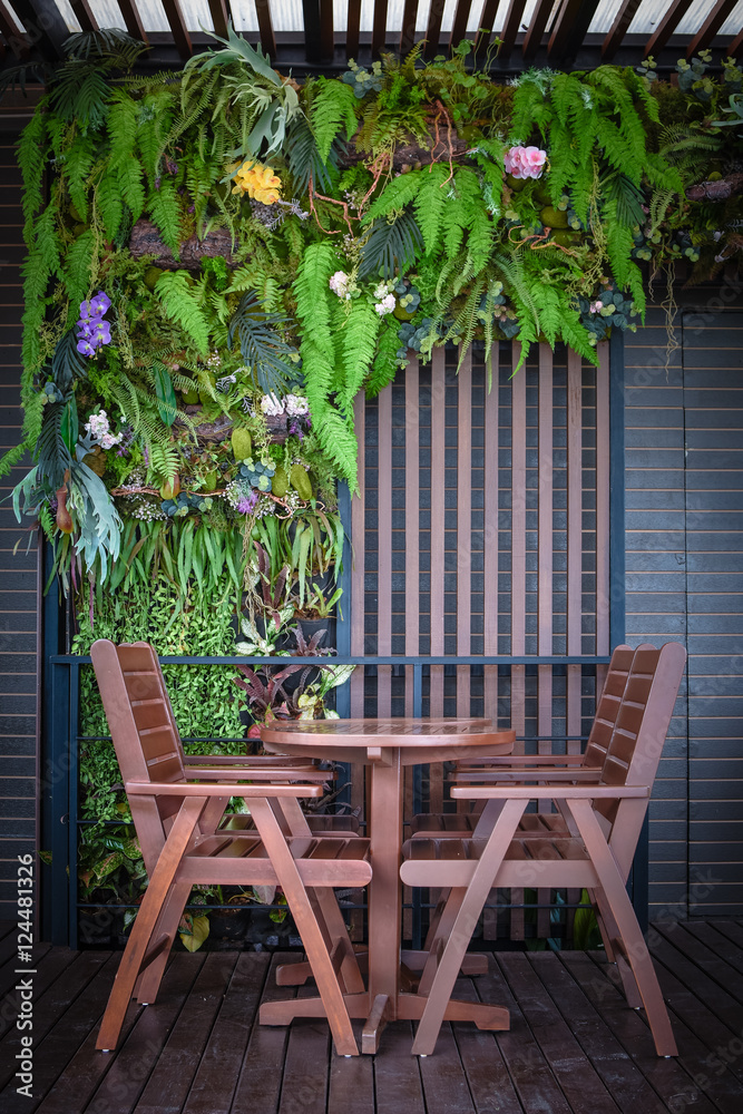 Fototapeta premium wooden table and chairs in the cafe. wooden chair and table at front porch. something on table in garden.