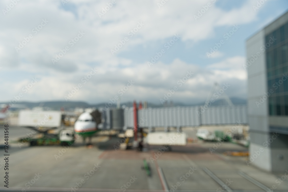 Abstract defocused bokeh of airplane at airport gate with sun coming out after the rain. Modern travel concept and wander lifestyle at sunset. Focus on raindrops with warm vintage filtered look