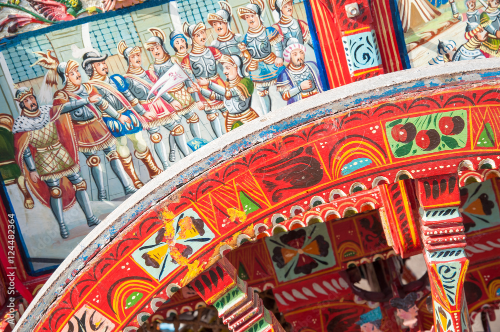 Close-up view of a colorful wheel of a typical sicilian cart during a folkloristic show