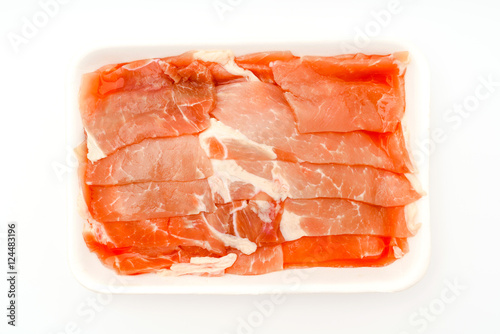 Slide of raw pork on white background .