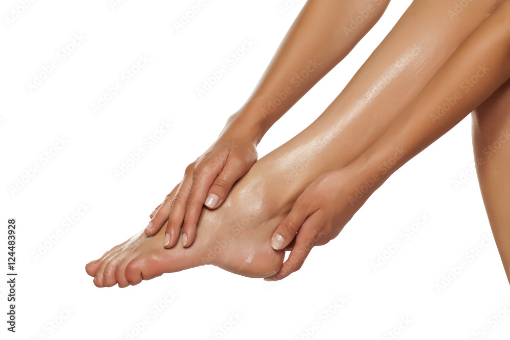 women applied the cream on her beautiful feet