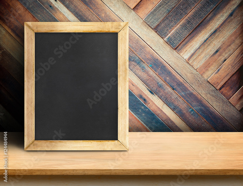 Blank blackboard on plank wooden table top at diagonal tropical