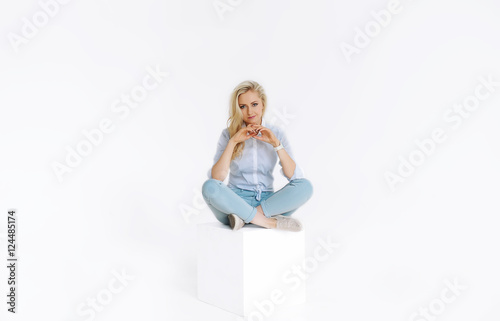 Wallpaper Mural Beautiful young woman sitting on white cube in studio Torontodigital.ca