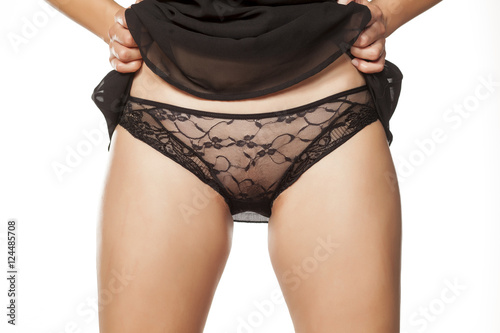 woman lifted her dress and shows her white black panties photo