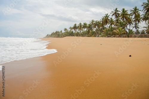 Tropical Azuretti beach on the Atlantic ocean coast in Grand Bassam, stock image. Ivory Coast, Africa. April 2013.