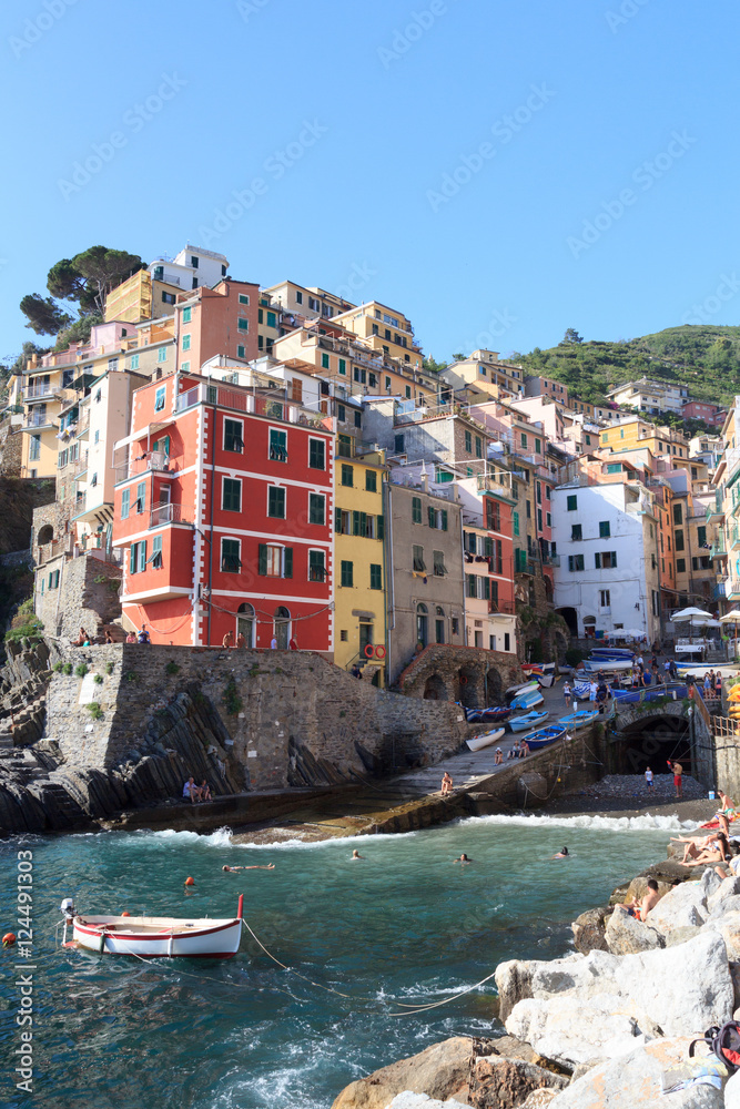 Port of Cinque Terre village Riomaggiore with colorful houses, Italy