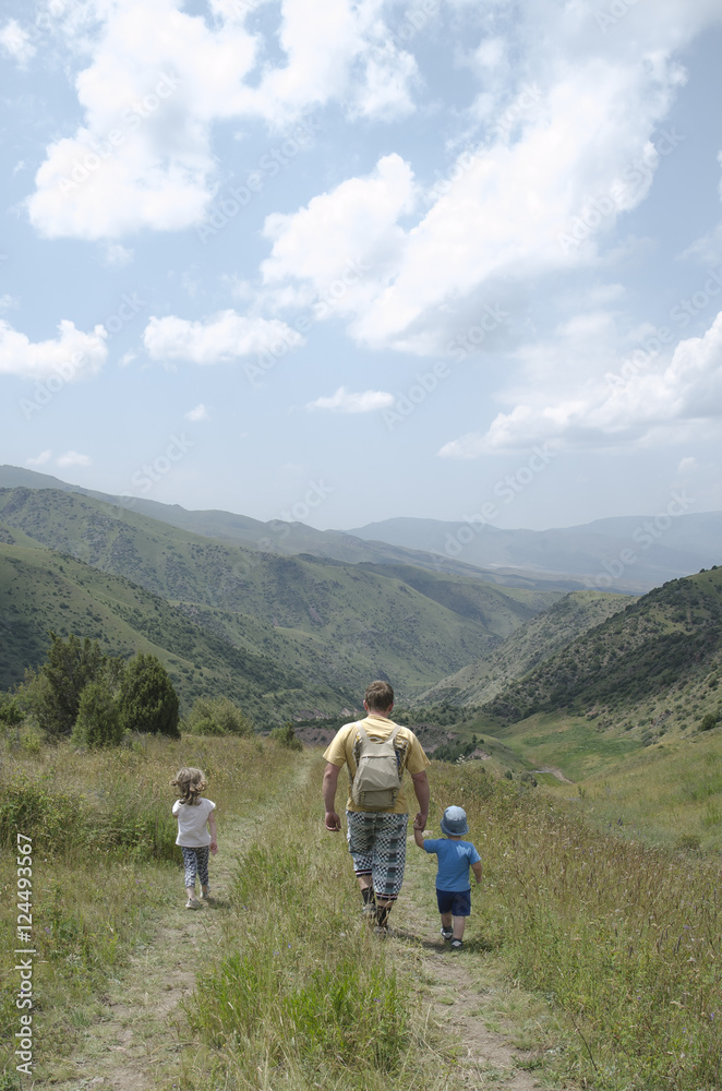 father with children walk in mountain