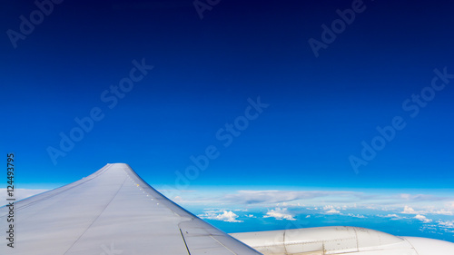 Wing airplane over blue sky © redkphotohobby