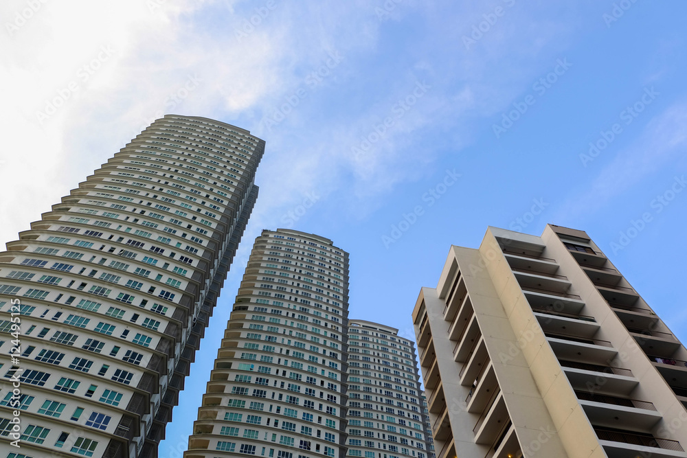 Modern high-rise apartment over blue sky background with color tone effect